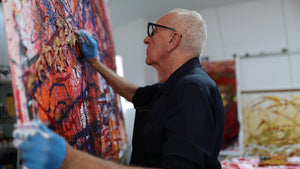 Artist John Berrick working on a large piece in his studio