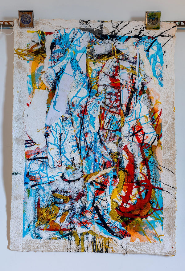 Abstract art piece with splashes of blue, red, yellow, and black on a textured surface. By John Berrick.