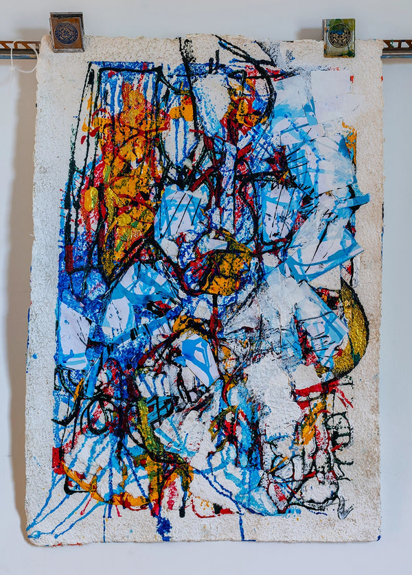 Abstract artwork with colorful splashes on a textured surface. By John Berrick.