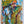 Abstract artwork with vibrant yellow, blue, and green colours on a white background. By artist John Berrick.