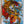 Abstract artwork with vibrant red, yellow and blue colours on a textured paper surface. By artist John Berrick.