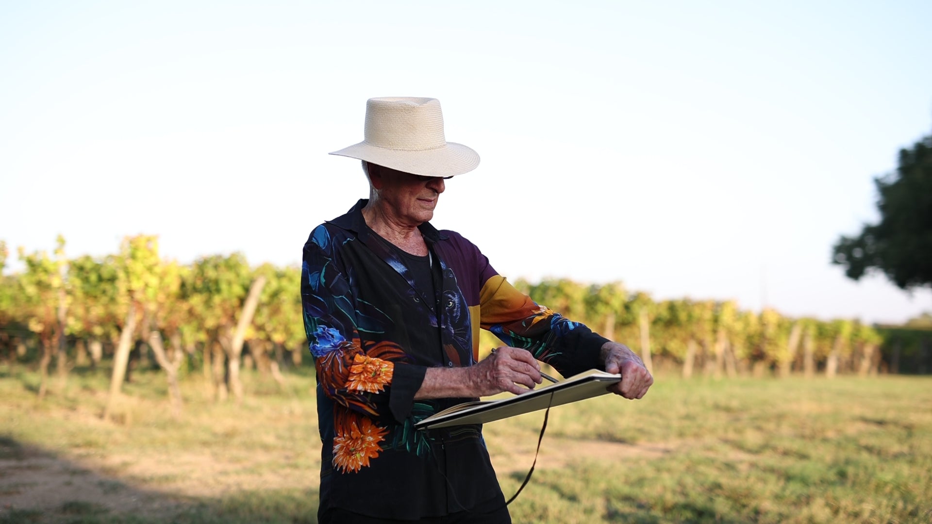 Artist John Berrick sketching a landscape scene en plein air